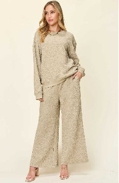 Woman wearing a beige textured outfit on a white background