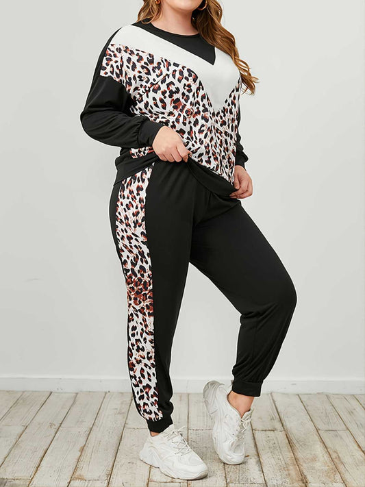 Person wearing a black and white outfit with leopard print accents on a light wooden floor.