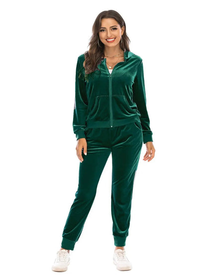 Woman wearing a green velvet tracksuit on a white background