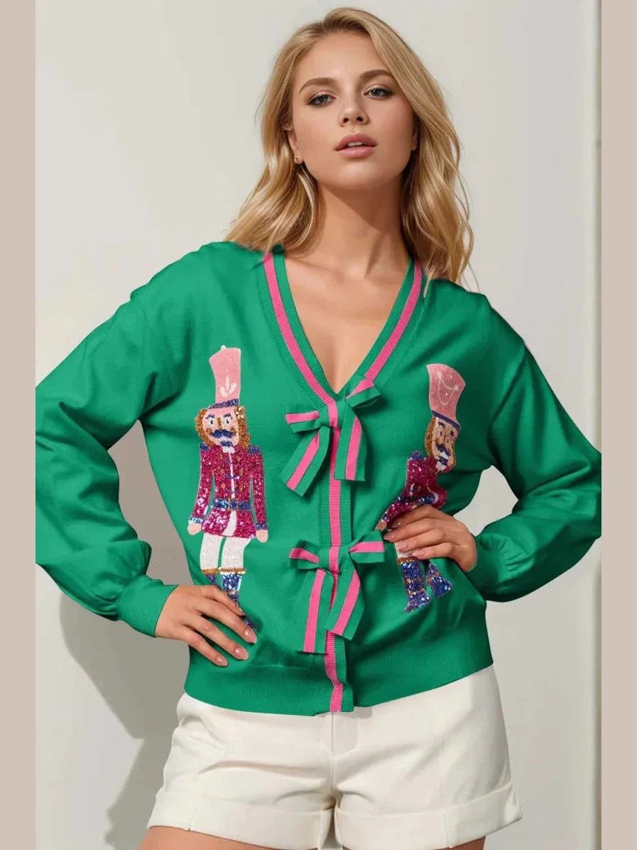 Woman wearing a green blouse with pink accents and decorative elements on a plain background