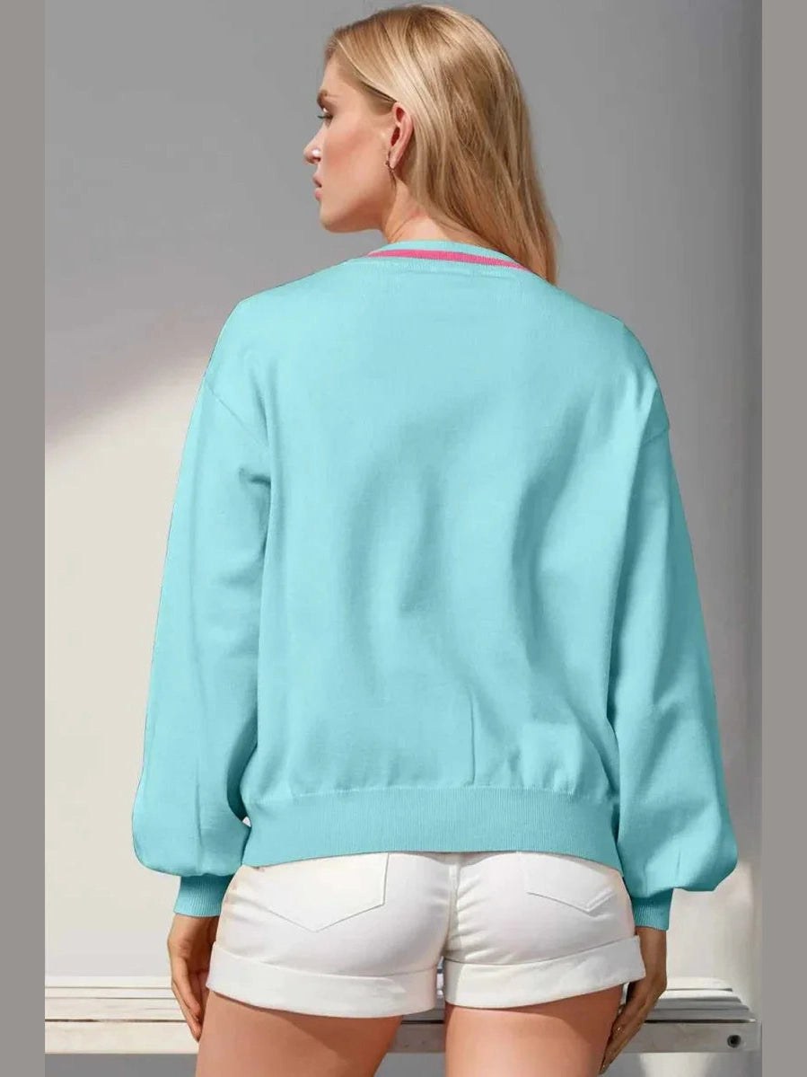 Woman wearing a light blue sweatshirt and white shorts against a gray background