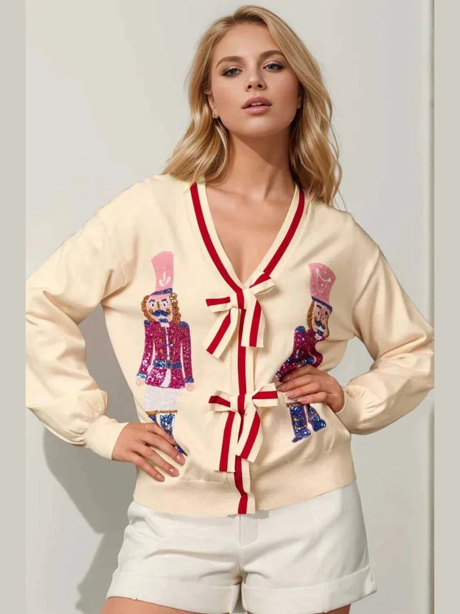 Double Take Full Size Nutcracker Sequin Bow Decor Cardigan – modest holiday cardigan with sequin nutcracker design and bow tie closure
