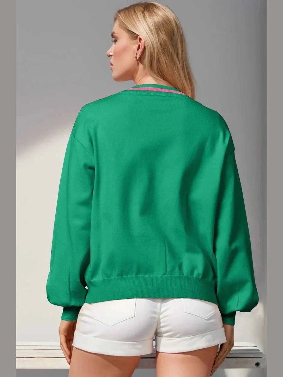 Person wearing a green sweatshirt and white shorts against a neutral background